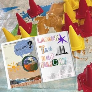Zine zum Thema Flucht und Weltspiel im Hintergrund